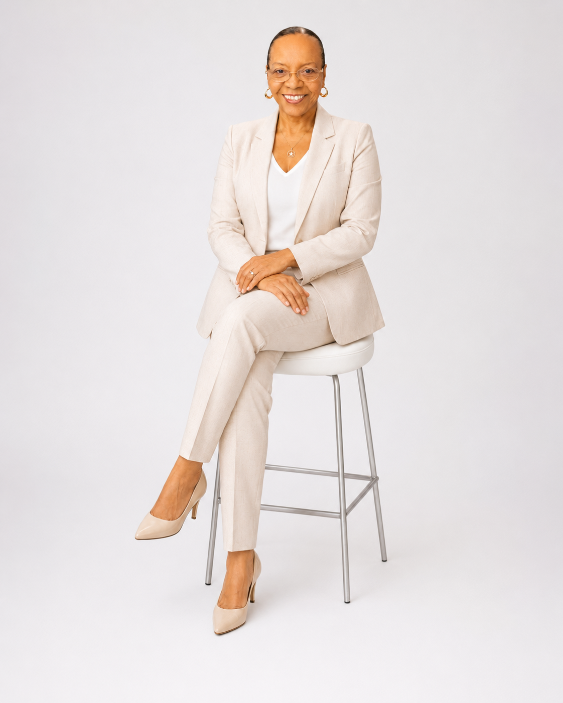 Irene Coleman, founder of IreneBuildsAI, seated in a cream suit